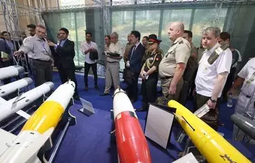 Foreign military advisors visit Iran's defense industry achievement exhibition in Tehran on August 23. [Atta Kenare/AFP]
