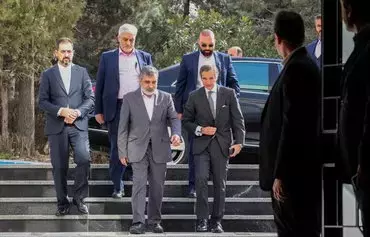 Behrouz Kamalvandi (L), Spokesperson for the Atomic Energy Organization of Iran, welcomes the International Atomic Energy Agency (IAEA) chief Rafael Grossi in Tehran on March 4. [Atta Kenare/AFP]