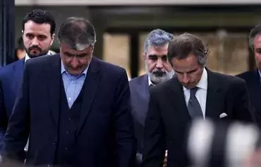 Atomic Energy Organization of Iran head Mohammad Eslami and International Atomic Energy Agency chief Rafael Grossi arrive for a press conference in Tehran on March 4. The UN nuclear watchdog chief was in Iran after the discovery of uranium particles enriched to near weapon-grade level. [Atta Kenare/AFP]