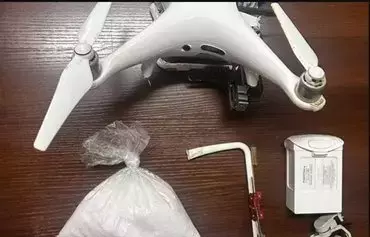 Jordanian security forces display a drone, with a bag of crystal meth it was carrying, that they shot down as it crossed into the kingdom from Syria on June 13. [Jordan Armed Forces - Arab Army]