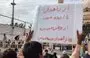 
Baluch protesters gather in Zahedan after Friday prayers on September 29. The sign held up by one protester reads, 'The homeland is bleeding, from Zahedan to Izeh. #ZahedanBloodyFriday.' [Social media]        