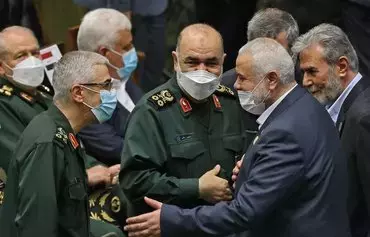 Hamas leader Ismail Haniyeh (2nd R), shakes hands with Iranian Chief of Staff for the Armed Forces Mohammad Bagheri (L) and IRGC commander Gen. Hossein Salami during the swearing in ceremony for Iranian President Ebrahim Raisi in Tehran on August 5, 2021. [Atta Kenare/AFP]