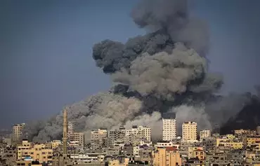 Smoke billows during Israeli air strikes in Gaza City on October 12. [Mahmud Hams/AFP]