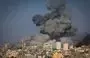 
Smoke billows during Israeli air strikes in Gaza City on October 12. [Mahmud Hams/AFP]        