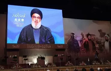 Supporters of Hizbullah attend a televised speech by the group's leader Hassan Nasrallah in Beirut's southern suburbs, on February 16. [Anwar Amro/AFP]