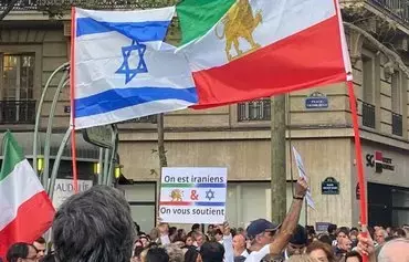 Iranians rally in Paris in solidarity with the Israeli government in October, holding signs in French that read, "We are Iranian, we support you (to the Israeli people). They also hold flags of Israel and Iran's Lion and Sun (the flag used before the 1979 Islamic Revolution). [Social media]