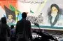 
A mural depicting Ayatollah Ruhollah Khomeini, Iran's first supreme leader since the 1979 Islamic Revolution, is pictured as people cross Enghelab Square in central Tehran on September 10. [ATTA KENARE / AFP]        
