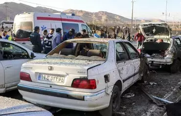This photograph taken on January 3 shows destroyed cars and emergency services near the site where two explosions in quick succession struck a crowd marking the anniversary of the 2020 killing of IRGC commander Qassem Soleimani, near the Saheb al-Zaman mosque in the southern Iranian city of Kerman. [Tasnim News/AFP]
