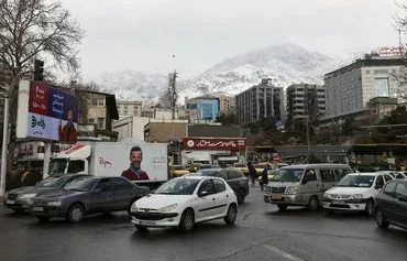 Cars pass the Tajrish Bazaar in Tehran on January 16, 2022. The US Treasury sanctioned an Iranian automaker and three of its subsidiaries on April 18 for materially supporting the IRGC. [Atta Kenare/AFP]