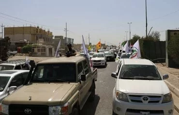 Iran-backed Iraqi militia Asaib Ahl al-Haq holds a military parade in a photo posted on X on May 7, 2021.