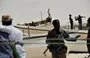 
Armed militiamen and pirates stand among fishing boats in the central Somali town of Hobyo in 2010. [ROBERTO SCHMIDT/AFP]        