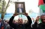 
A man holds a portrait of killed Hamas chief Ismail Haniyeh during a rally at Tehran University on July 31. [AFP]        