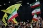 
People wave Iranian and Hizbullah flags during a rally to mourn the death of Iranian President Ebrahim Raisi, in Beirut's southern suburbs on May 24. [Anwar Amro/AFP]        