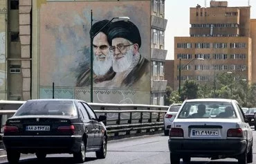 A mural in Tehran shows Islamic Republic founder Rouhollah Khomeini and Iranian leader Ali Khamenei on September 10, 2023. [Atta Kenare/AFP]