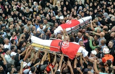 Residents of Nahr al-Bared Palestinian refugee camp in northern Lebanon gather September 30 for the funeral of Popular Front for the Liberation of Palestine commanders. [Fathi al-Masri/ AFP]