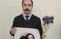 
Civil rights activist Hossein Ronaghi, protesting with his lips sewn shut, holds a poster of Nasreen Shakarami and her teenage daughter Nika, who was killed by Iranian security forces in September 2022. [Hossein Ronaghi X account, November 24]        