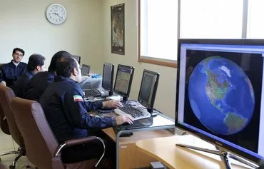 Personnel monitor satellite signals at the Alborz Space Station in Mahdasht, Iran, February 29, 2012. [Atta Kenare/AFP]