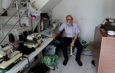 Power outage halts work at a Tehran tailor shop, May 23, 2021. [Atta Kenare/AFP]