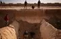 
People search for remains in a suspected mass grave near Damascus, December 16, 2024. [Aris Messinis/AFP]        